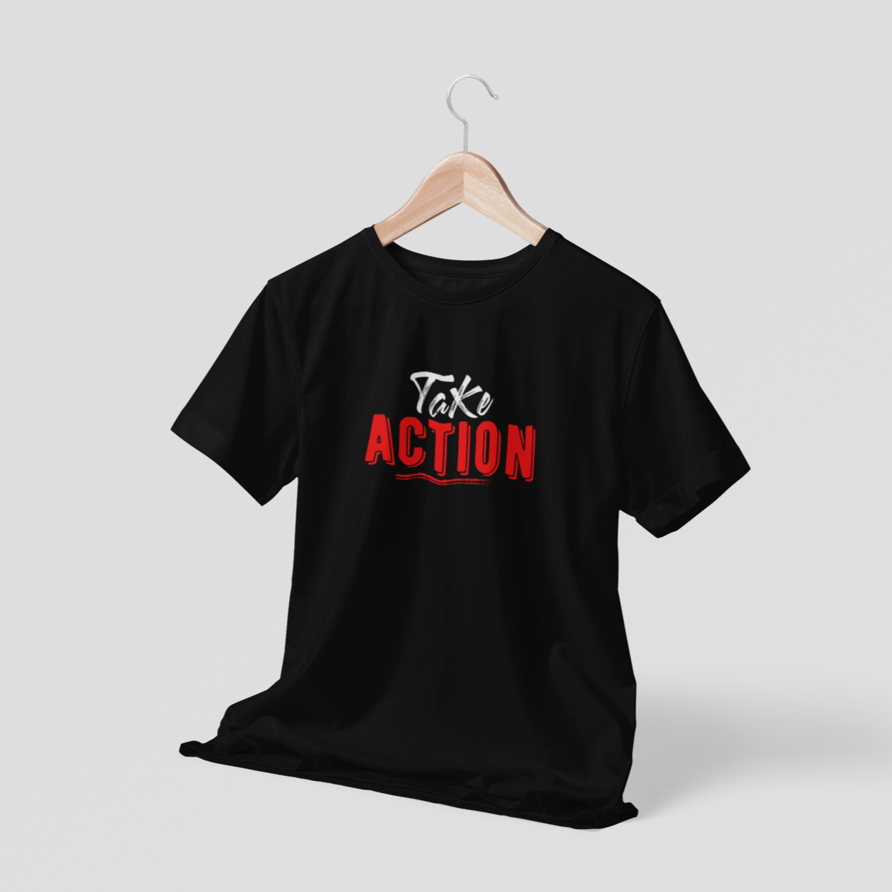 Black t-shirt with 'Take Action' text on a hanger against a gray background